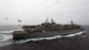 AT SEA -- The amphibious assault ship USS Boxer (LHD 4), background, receives a vertical replenishment-at-sea from the fast combat support ship USNS Arctic (T-AOE 8) in the Gulf. July 14, 2019