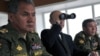 Russia -- Russian President Vladimir Putin (C), Defense Minister Sergei Shoigu (R) and Chief of General Staff Valery Gerasimov (R) watch as the Russian Army and Navy conduct exercises near the eastern Siberian city of Chita, 17Jul2013