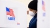 U.S. -- A person stands in a voting booth while preparing to cast a paper ballot at a polling location inside Show Place Arena in Upper Marlboro, Maryland, USA, 02 November 2020.